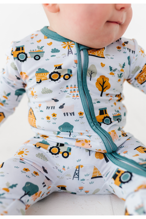 Sawyer Bamboo Fabric Baby Zip Romper Farm Animals Print on Baby Model by Bird and Bean