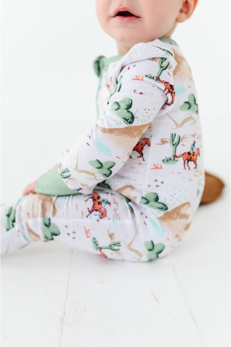 another close up shot of billy western zip up one piece romper on sitting child model