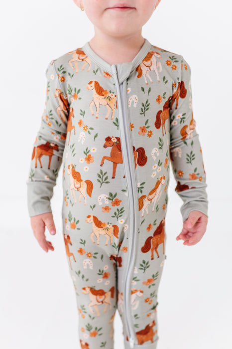 Bamboo One Piece Zip Pajama -Horsin' Around Print Close-up on Child Model _ Bird and Bean Original 