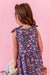 Young girl wearing a floral  print sundress against a pink background | Bird and Bean 