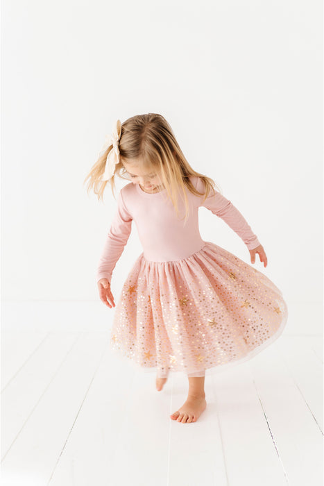 Young girl wearing a pink dress with a white background | Bird and Bean Holiday