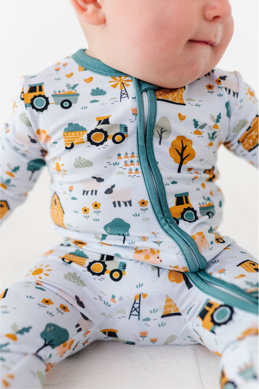Sawyer Bamboo Fabric Baby Zip Romper Close-up on BabyModel  Farm Animals  and Farm Scene Print by Bird and Bean