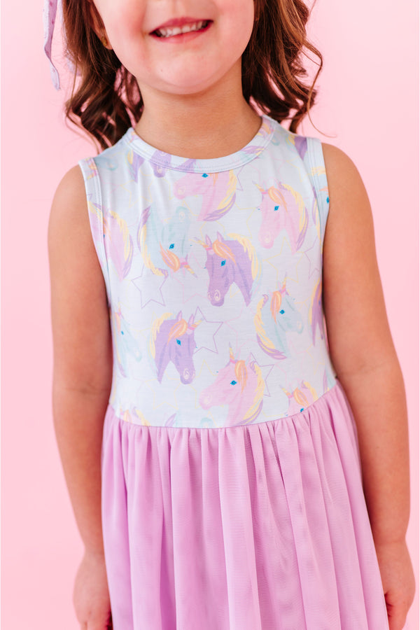 Child wearing a tulle skirt bamboo dress with unicorn pattern on a pink background | Bird and Bean Kids