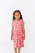 Young girl wearing a pink cherry print tank dress bamboo fabric  on a white background | Bird and Bean 