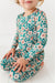 Child wearing a floral Pajamas set  with long sleeves and pants on a white background