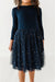Navy dress with a tulle overlay featuring star patterns on a white background | Bird and Bean Holiday