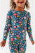 Another close up of child model in Bamboo Maren Peach, gold, and pink flower navy pajama set