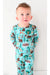 Boy model stands in green blue bamboo Woody Woodland Bear pajama set