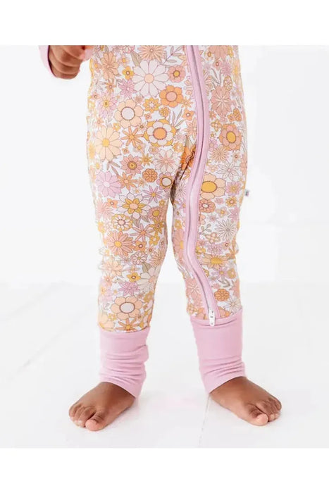 Close up of baby model in Ivy Pink Orange Floral Baby Bamboo Zip Romper Sleeper 