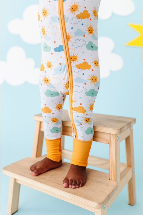 Close up of baby model standing in Sunny Sunshine Convertible Bamboo Zip Romper Sleeper Onesie with Marigold Cuffs