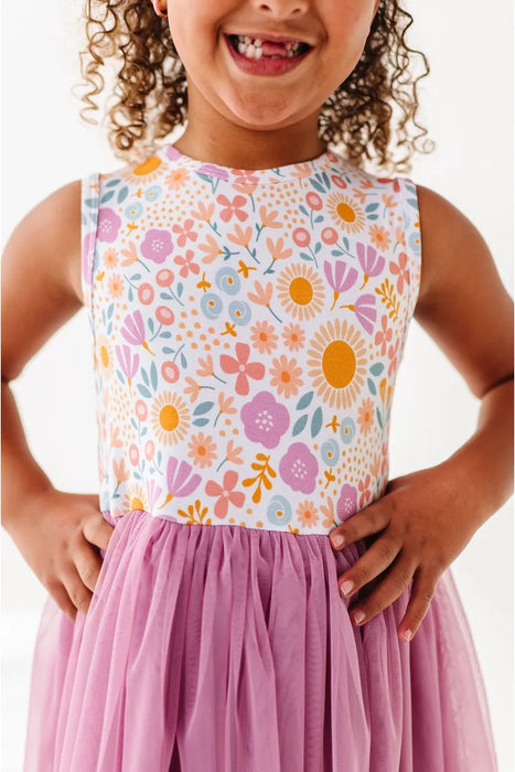 Close up of girl model wearing Darling Spring Daisy bamboo tulle dress with peach, lilac, golden, and sage blooms