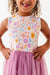 Close up of girl model wearing Darling Spring Daisy bamboo tulle dress with peach, lilac, golden, and sage blooms