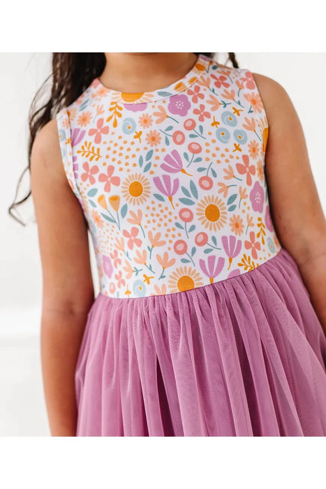 Close up of model wearing Darling Spring Daisy bamboo tulle dress with peach, lilac, golden, and sage blooms