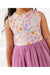 Close up of model wearing Darling Spring Daisy bamboo tulle dress with peach, lilac, golden, and sage blooms