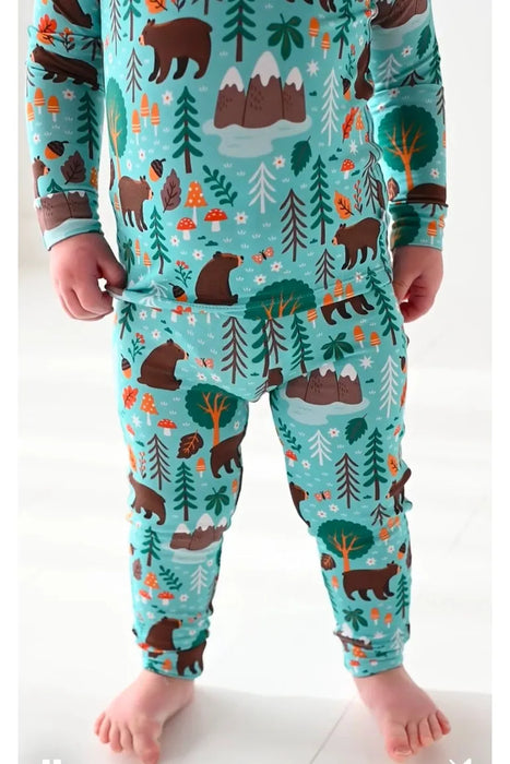 Closeup of boy model wearing green blue bamboo Woody Woodland Bear pajama set