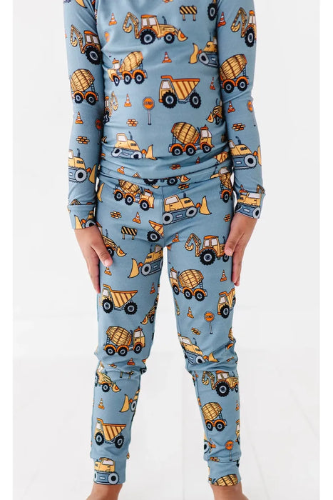 Cropped image of boy model in blue bamboo Construction Worksite truck pajamas