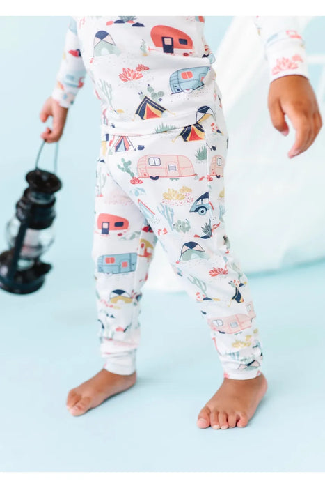 Cropped lower half view of kid model wearing Bamboo Desert Adventure Happy Camper Tents and Cactus Kids Pajama Set holding lantern in front of studio set