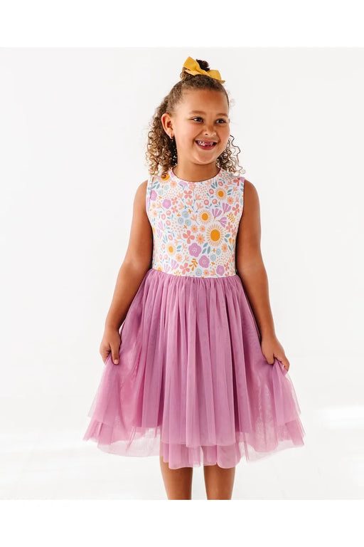 Girl model wearing Darling Spring Daisy bamboo tulle dress with peach, lilac, golden, and sage blooms