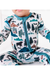A close-up of a baby wearing a long-sleeve footless zip-up sleeper with a colorful forest and mountain print on a white background. The print features pine trees, bears, mountains, and cabins in shades of teal, black, brown, and blue. Into the Wild Print by Bird and Bean Kids