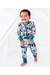 A smiling toddler stands barefoot in a white studio setting, wearing a one-piece zip-up pajama with a scenic outdoor print in teal, black, brown, and white. Into the Wild Bird and Bean Print 
