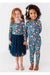 Two child models, one in Bamboo Maren Peach, gold, and pink flower navy pajama set and one in matching Bamboo Maren Navy Tulle dress