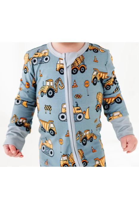 close up of Baby model wearing Construction Worksite Bamboo Zipper Pajamas with vehicles