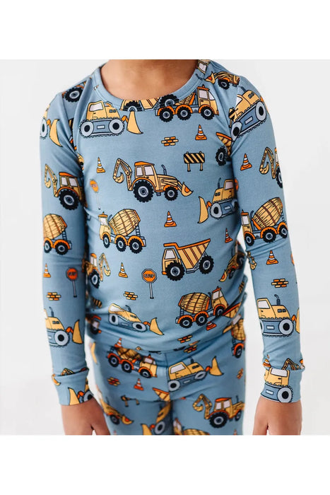 close up of Boy model in blue bamboo Construction Worksite truck pajamas