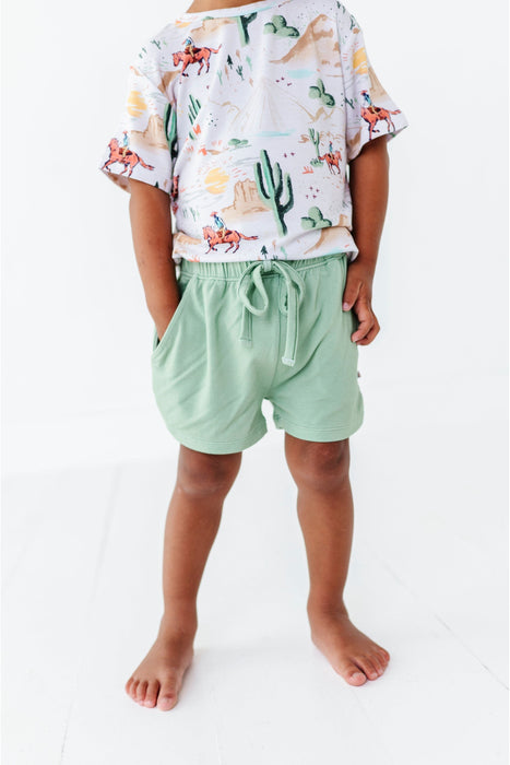 closeup of child model wearing billy cowboy western short and shirt set demonstrating pocket