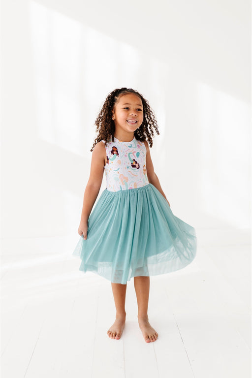 girl model twirling in a blue tulle mermaid skirt dress