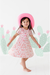 girl model wearing pink cowboy hat wearing Dixie cowboy western pink bamboo dress with cactus designs in background of image