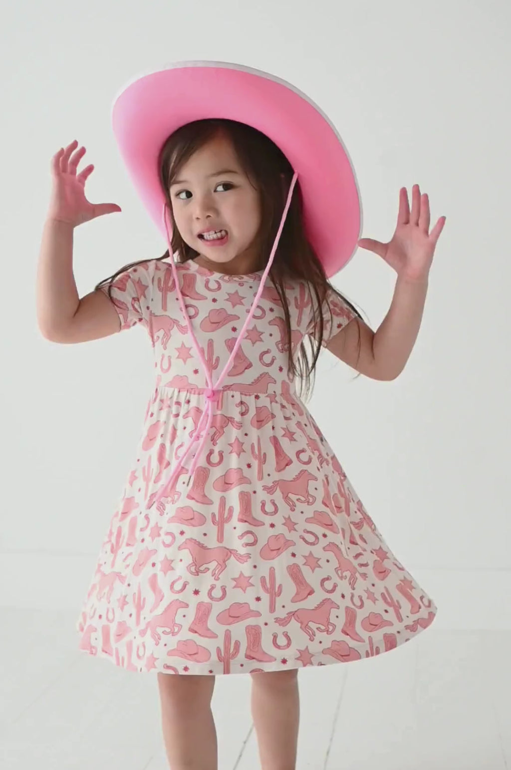 video of girl model twirling in dixie cowboy western pink bamboo short sleeve dress