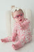 video of sitting baby model wearing Dixie pink cowboy western themed zipper romper pajama