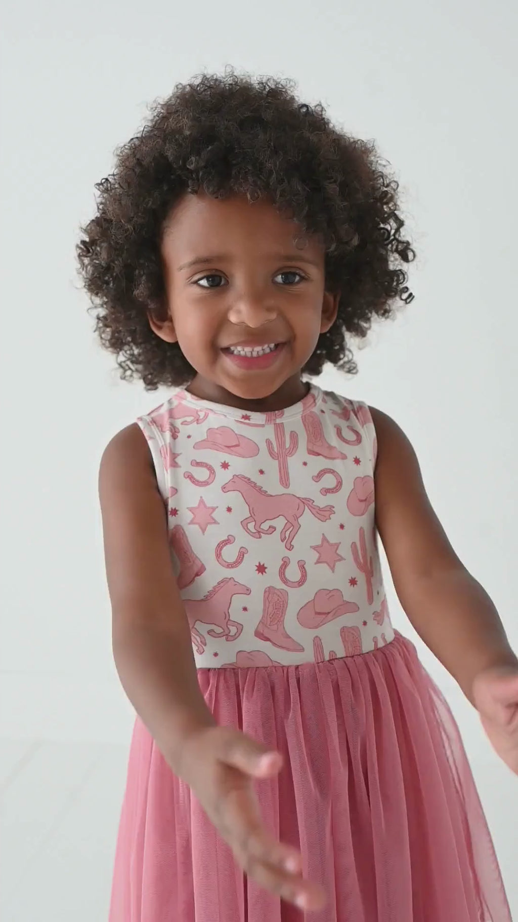 video of girl model laughing and twirling skirt in Dixie Western bamboo pink tulle skirt tank dress in studio